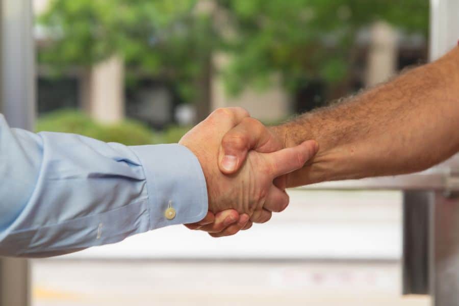 Divorce attorney shaking hands with client